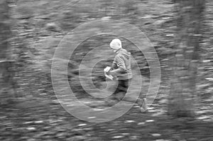 Motion blur. Athlete runs through the forest