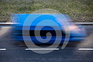 Motion blur of a blue delivery van