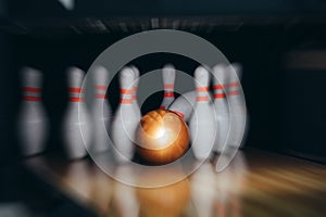 Motion blur of bowling ball and skittles on the playing field