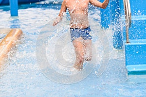 Motion blur boy running in pool.