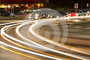 Motion Blur Of Car Headlights Turning At Busy Intersection