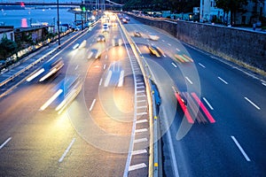 Motion blur car viewed from the road bridge in big modern city