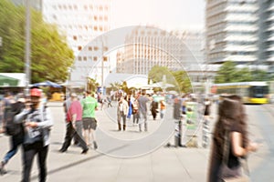 Motion blur of a crowd of people crossing a city street at the