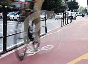 Motion blur of cyclist over red lane.