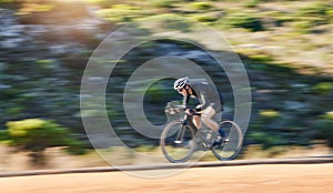 Motion blur, fitness and cyclist on bicycle on road in mountain with helmet, exercise adventure trail and speed. Cycling