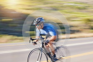 Motion blur, fitness and cyclist on bike on road in mountain with helmet, exercise adventure trail and speed. Cycling