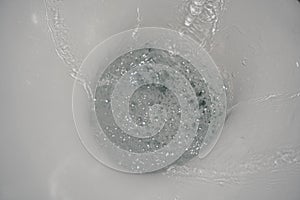 Motion blur of flushing water in toilet bowl. Toilet bowl flush. Selective focus of flushing water in ceramic toilet.