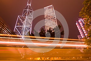 Motion blur in front of skyline of office buildings at Admiralty, Chung Wan Central District, Hong Kong Island, Hong Kong photo