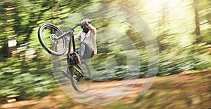 Motion blur of mountain bike man, action jump and bicycle speed adventure, freedom and fast race in woods. Cycling