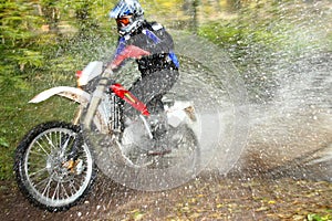 Motion blur, offroad motorbike crossing river