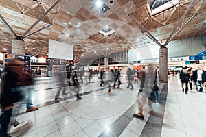 Motion blur of people walking in public exhibition hall. Business tradeshow, job fair, or commercial activity concept photo