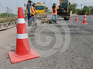 Motion blur, road construction with a red rubber cone in front