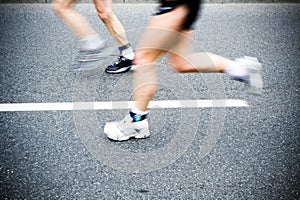 Motion blur of running man in marathon, sport shoe