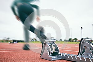 Motion blur, running and race start blocks with athlete on stadium, person and speed, action and fitness outdoor