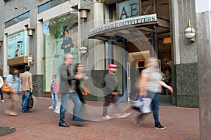 Motion Blur Of Shoppers Passing Storefront In San Francisco