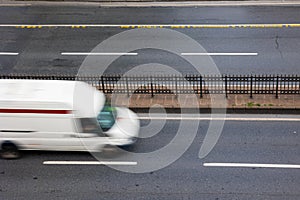 Motion blur of the vehicles on the two lanes road from high angle view