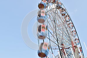 A motion blur view giant wheel or ferris wheel with the background of blue sky at india