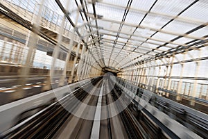 Motion Blur View of Train Tracks Inside Modern Covered Tunnel
