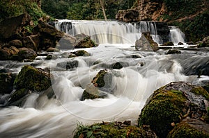 Waterfall in forest with cascade river in Belarus