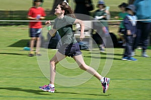Motion blur of a young girl running outdoors