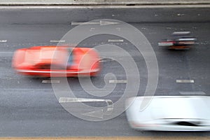 Motion blurred of automobile moving on road with speed on top view