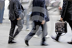 Motion blurred business people walking on the street