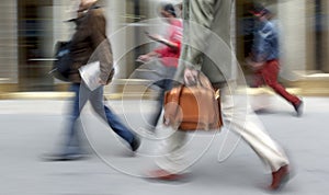 Motion blurred business people walking on the street