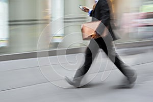 Motion blurred business people walking on the street