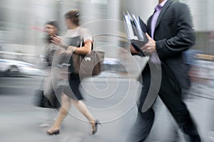 Motion blurred business people walking on the street