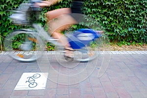 Motion blurred cyclists to show speed, driving along a bike lane, and make transport and urban displacements more sustainable