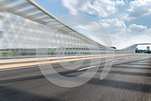 motion blurred defocused asphalt road on the bridge in downtown with cloudy sky..