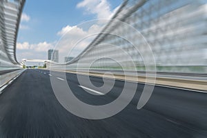 motion blurred defocused asphalt road on the bridge in downtown with cloudy sky