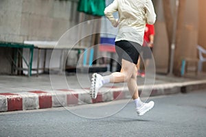 Motion blurred marathon runners in a city