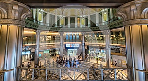 Motion blurred people conmuting and stainless steel columns at Tokyo Station