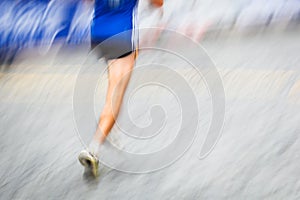 Motion blurred runner's feet in a city environment