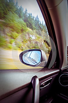 Motion blurred speeding car on country road