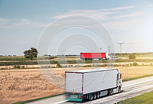 Motion blurred trucks on highway. Transportation