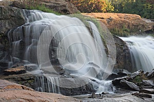 Motion-blurred waterfall cascading over rocks.