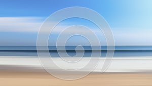 A motion blurry image of a beach with a blue sky in the background.