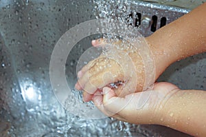 Motion capture washing child hands in the kitchen