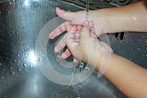 Motion capture washing child hands in the kitchen