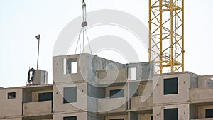 Motion of a crane transporting block on the building.