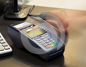 Motion of Hand Swiping Credit Card