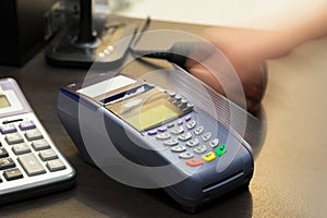 Motion of Hand Swiping Credit Card
