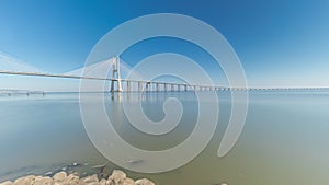 Motion from the low to high tide next to Vasco da Gama Bridge in Parque das Nacoes timelapse in Lisbon, Portugal.