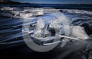 Motion movement iceberg at beach at Jokursarlon, Iceland with slow shutter technic