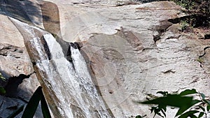 Motion movement of waterfall flowing down to water stream in tropical nature forest Thailand