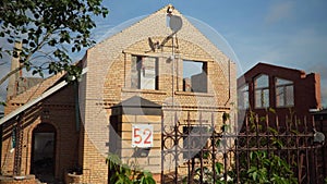 Motion past brick cottage ready for demolition in village