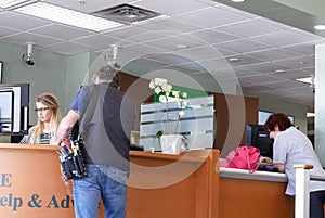 Motion of people talking to the teller at service counter inside TD bank