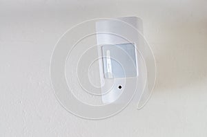 Motion sensor or detector for security system mounted on wall photo